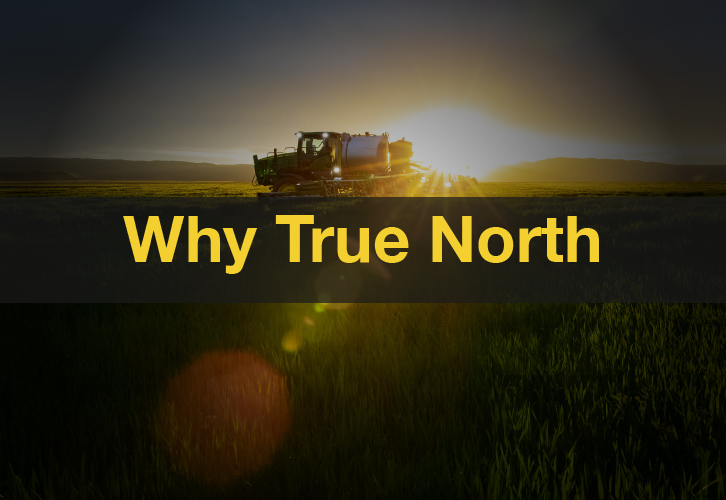 John Deere tractor in field at sunrise