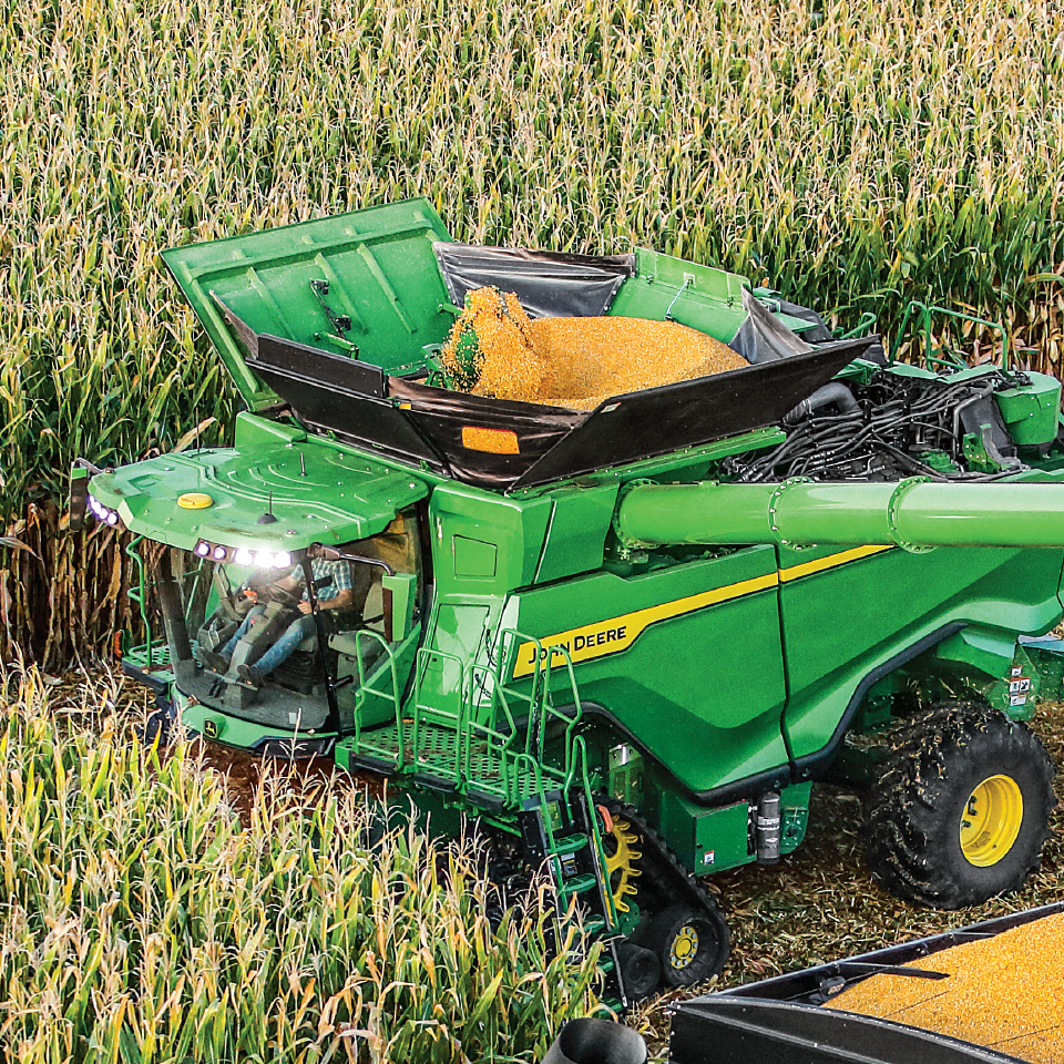John Deere combine in corn field daytime